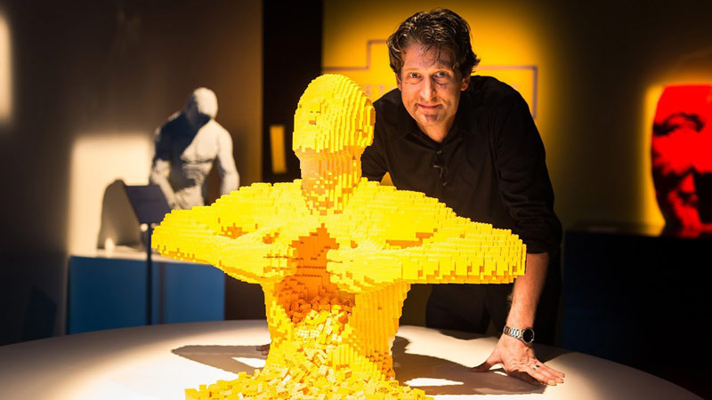 The brickartist Nathan Sawaya with one of his three-dimensional sculptures at the Art of the Brick exhibition